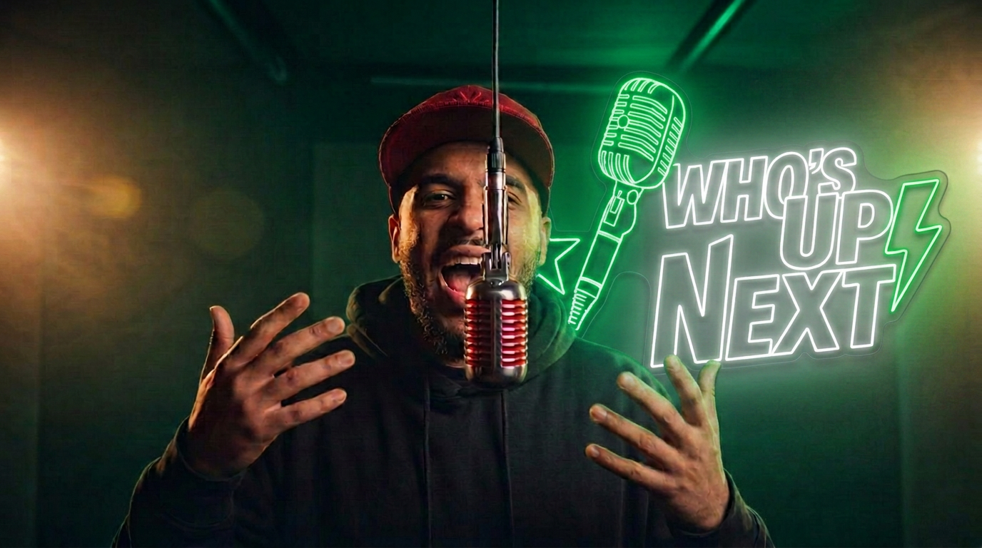 Rapper performing under a red spotlight in the Who's Up Next booth